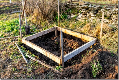 Vegetable winter garden raised bed cold frame in Ukraine dacha with dug up soil for vegetable patch and nobody