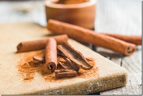 Cinnamon sticks and milled cinnamon spice on old table.